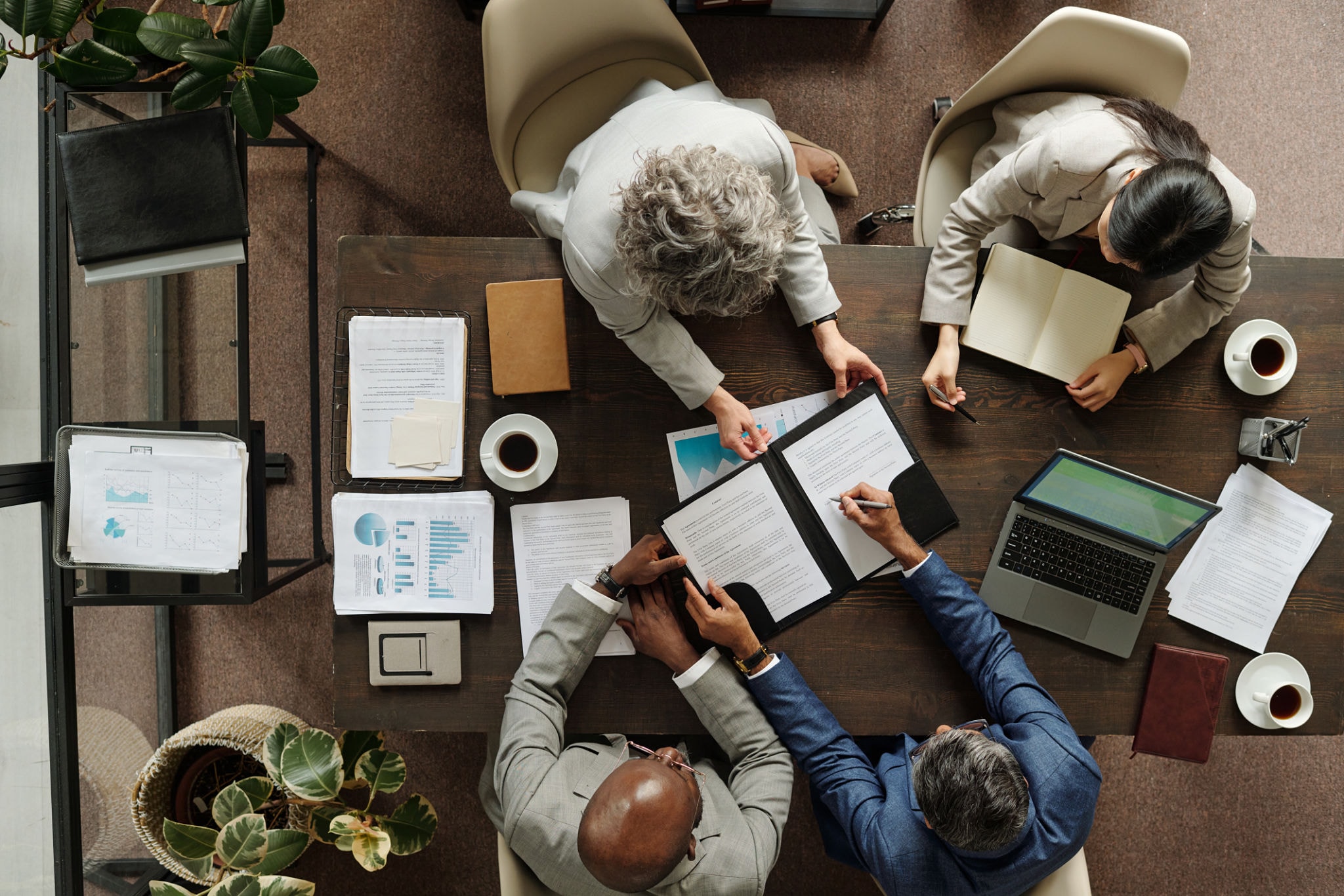 Large team gathered around a conference table for an organizational meeting